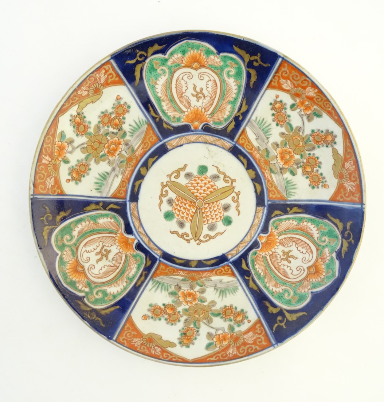 An Imari charger decorated with panels depicting flowers and foliage with gilt highlights. Approx.
