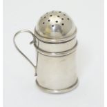 A silver novelty pepper formed as a flour shaker.