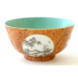 A Chinese tea bowl with four hand painted monochrome landscapes in roundels.