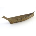 A North American / Canadian scale model of a Northwest Pacific tribal canoe having birds head bow