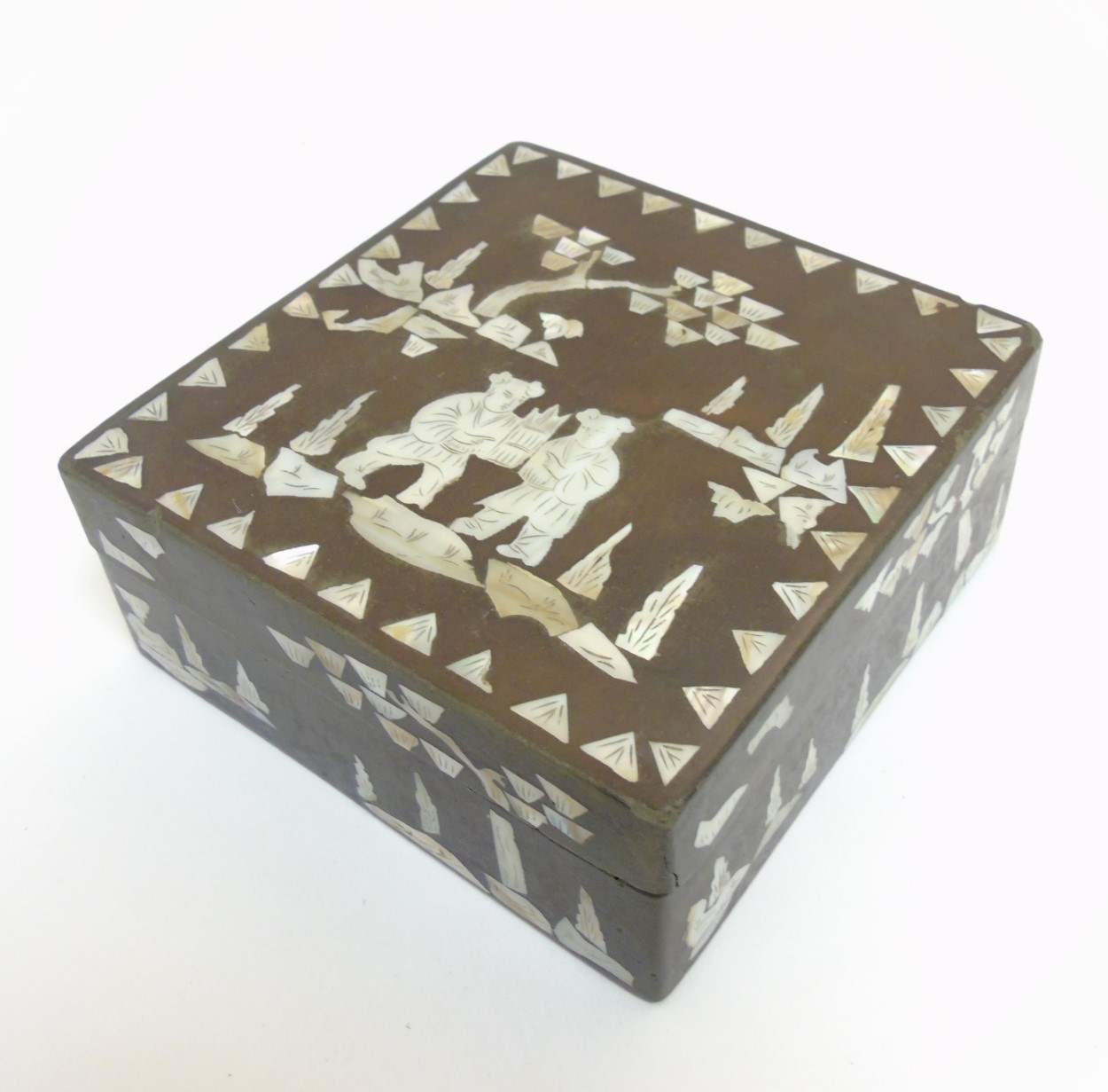 An Oriental lacquered box with mother of pearl and penwork inlay.