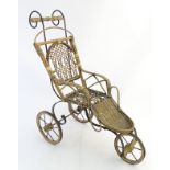 An early 20thC wickerwork and iron doll's pushchair formed as a trike,