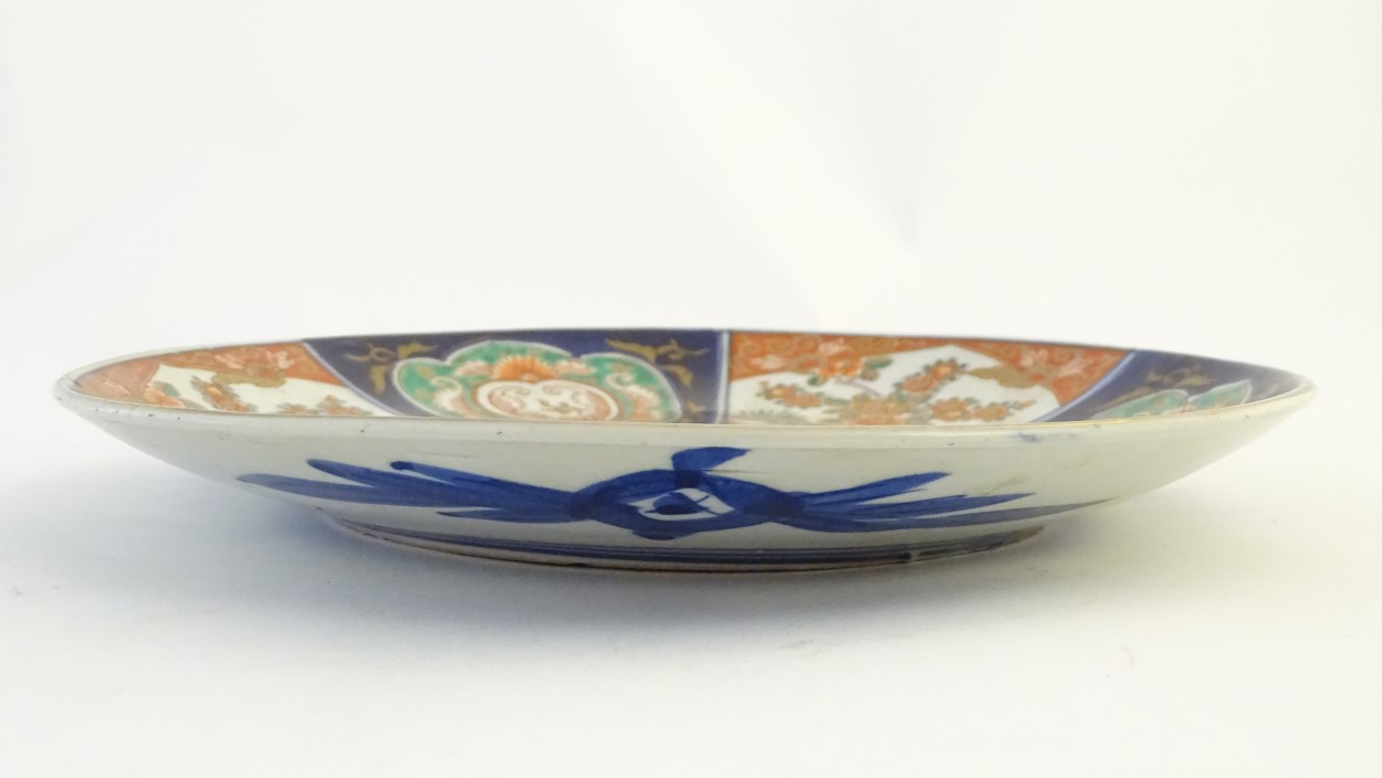 An Imari charger decorated with panels depicting flowers and foliage with gilt highlights. Approx. - Image 3 of 3