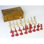 A 19thC turned bone and stained bone chess set, largest approx. 3 1/4". Contained in a wooden box.