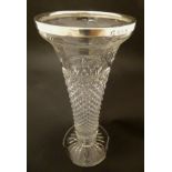 Glass : A tall pedestal moulded glass vase with hobnail decoration and swags and bows etc.