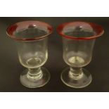 Glass : A pair of 19thC pedestal wine ? glasses each with cranberry rims and scarred pontil bases,