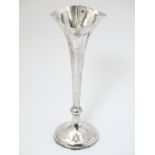 A silver bud vase with flared rim hallmarked London 1898 maker Horace Woodward & Co Ltd.