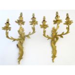 Wall Lights: a pair of mid 20thC Rococo three branch wall lights (electrified) of acanthus form,