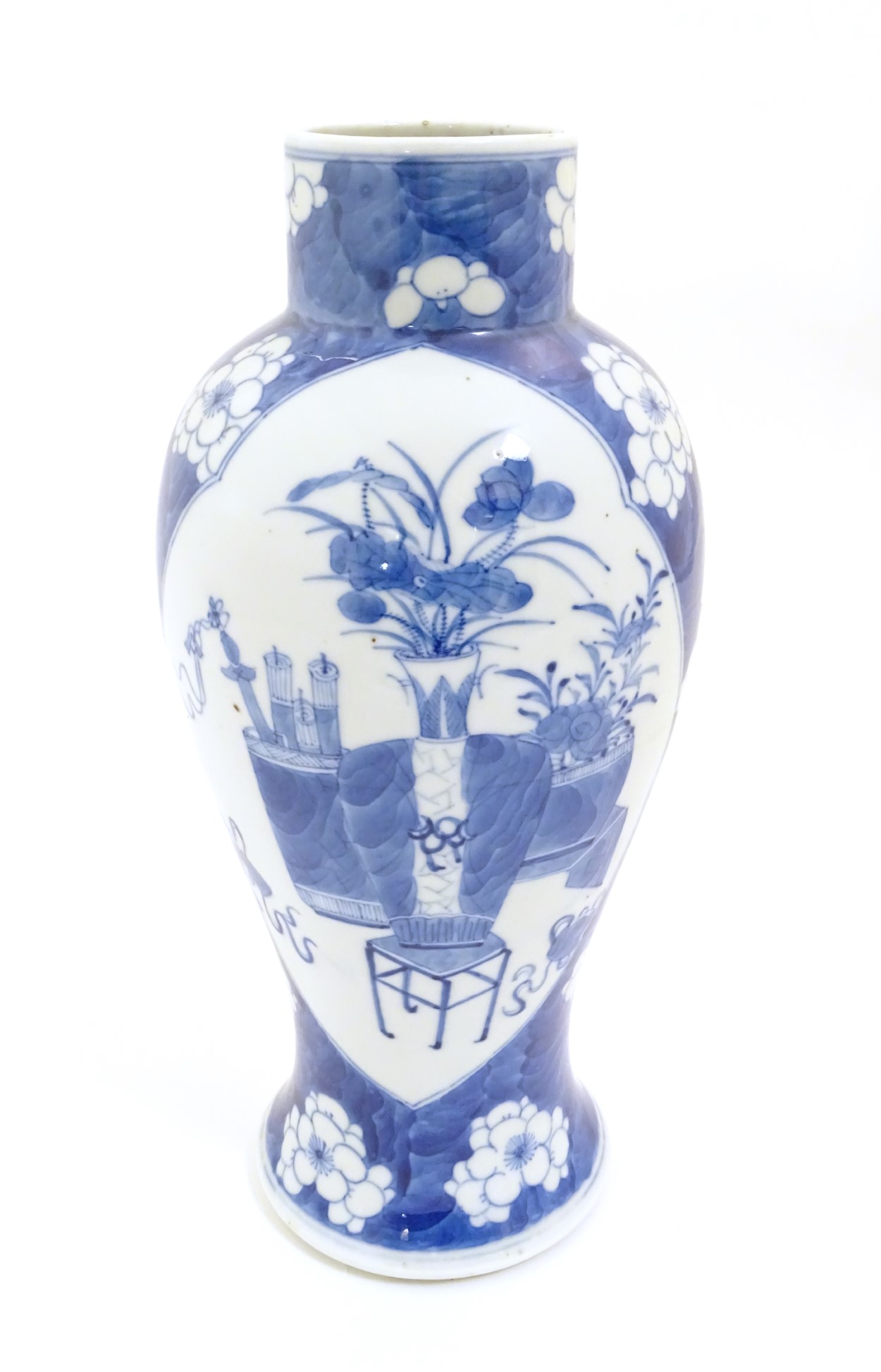 A Chinese, blue and white baluster vase decorated with prunus flowers,