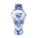 A Chinese, blue and white baluster vase decorated with prunus flowers,