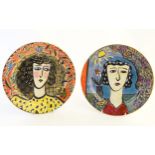 A pair of hand painted plates by Anna Anneli,