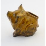 A mid 20thC continental ceramic match holder/vesta keep formed as a seated pig. Approx. 4" high.