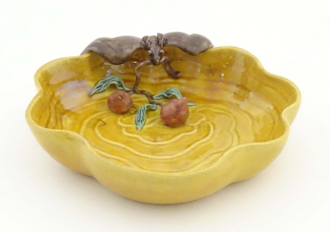 A Chinese wavy edged yellow brush wash dish with bat and fruit decoration,