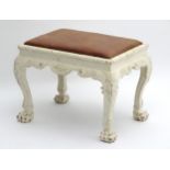 A 19thC William Kent style stool with carved scrolling decoration and acanthus carved knees,