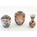 Three Imari vases decorated with panelled floral designs. Largest approx.