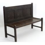An 18thC and later oak Wainscot style bench,