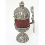 An East Asian white metal table snuff with carnelian hardstone body on a pedestal base.