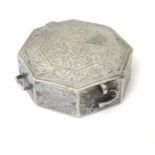 An Octagonal formed white metal box with hinged lid.