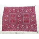 Rug / Carpet: a handmade dark red woollen ground rug, possibly Persian, with cream,