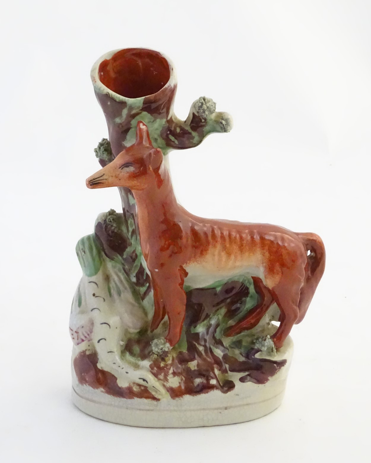 A Staffordshire flat back spill vase formed as a tree trunk with a fox and a goose on an oval base.