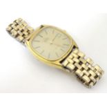 Omega DeVille: a gold plated Quartz date aperture gentleman's wristwatch with gold plated strap,