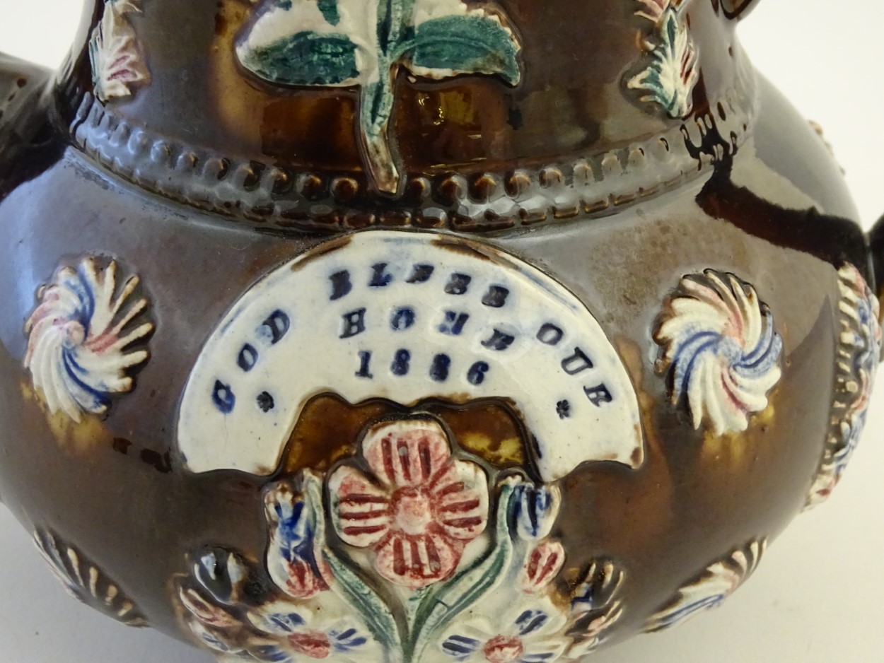 A late 19thC Measham bargeware teapot and cover with floral decoration surrounding a plaque - Image 8 of 8