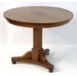 A mid / late 19thC mahogany tilt top table with a triform base raised on bun feet.