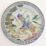 An 18thC Chinese plate decorated with a mythological landscape scene, possibly Minerva,