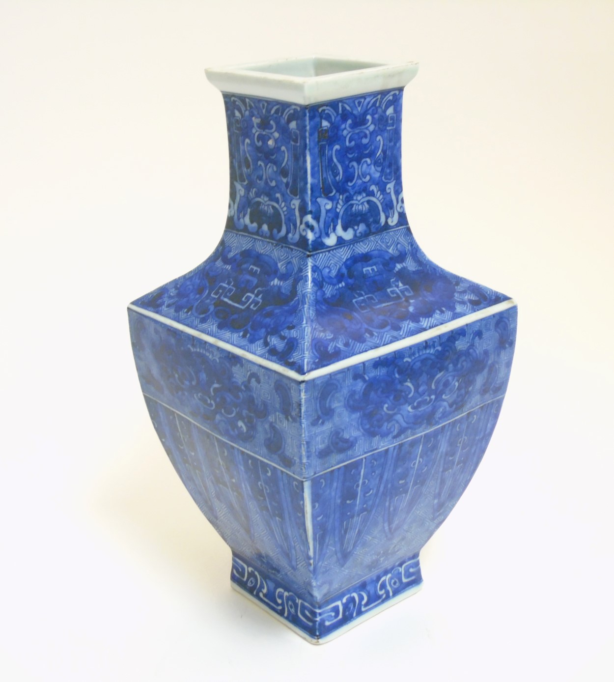 A Chinese blue and white square section vase, with archaic style decoration ,