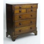 A mid / late 18thC oak chest of drawers with two short drawers and four long,