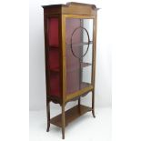 An Edwardian mahogany display cabinet with decorative stringing,