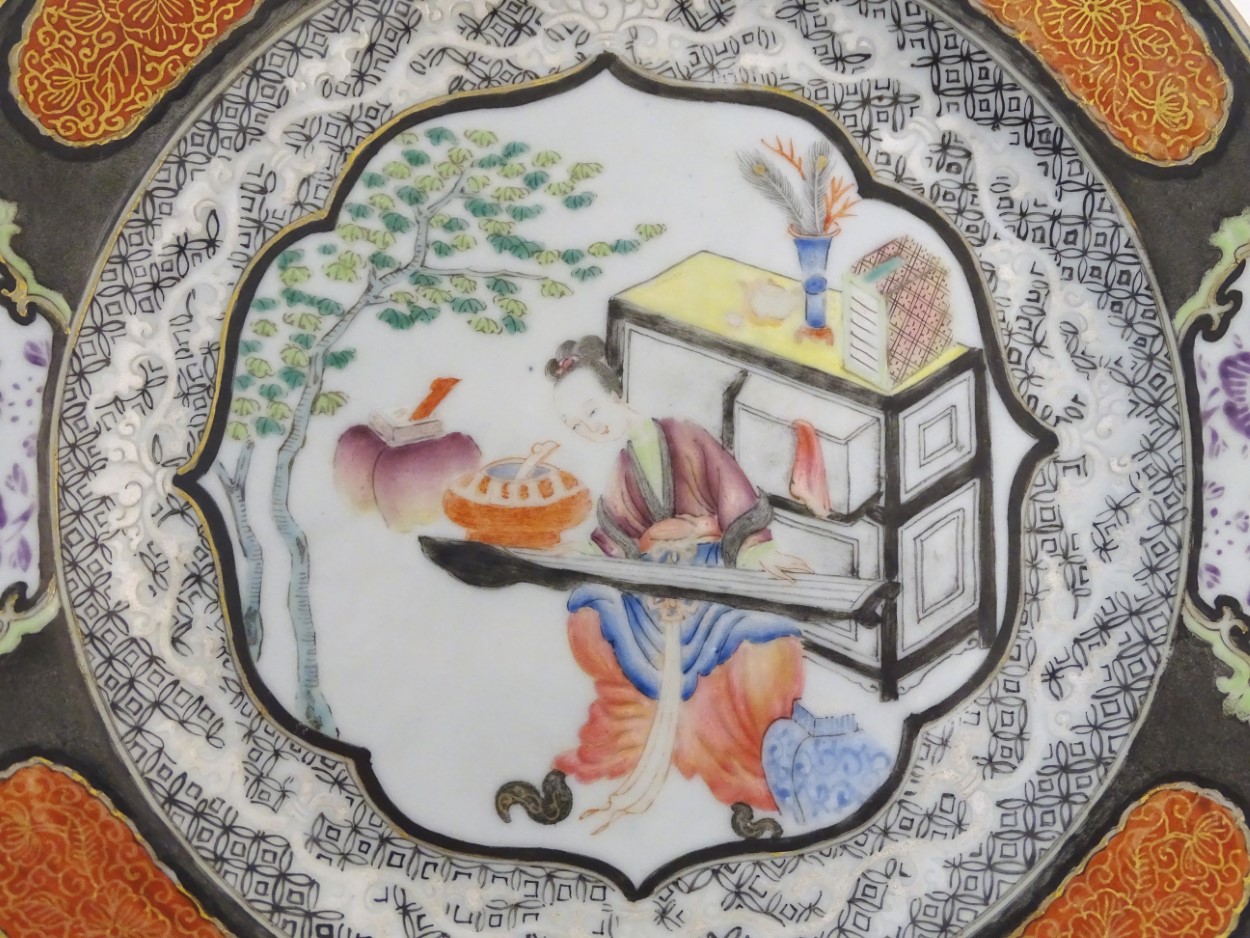 An 18thC Chinese plate decorated with a central panel depicting a lady playing a guqin instrument, - Image 2 of 3