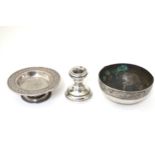 A small white metal tazza together with a dish ( probably Indian) and a short silver candlestick