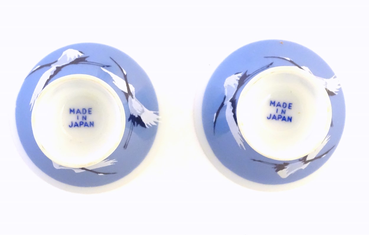 A pair of Japanese porcelain sake cups advertising Hakutsuru, decorated with flying cranes. - Image 8 of 8