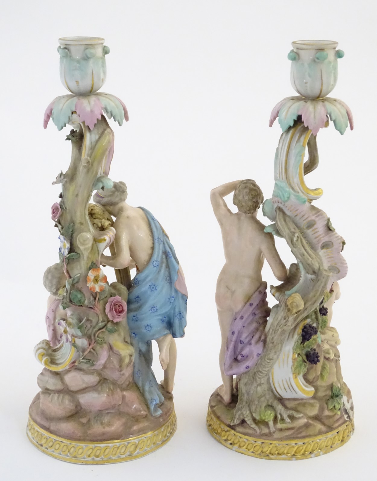 Two Meissen porcelain candlesticks, one depicting Bacchus and a child with vines and grapes, - Image 4 of 7