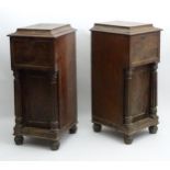 A pair of Regency mahogany dining room pedestals with lifting sarcophagus shaped lids above flame