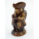 A treacle glazed Toby jug with tricorn hat, 'The snuff taker''. Height approx. 9 1/2''.