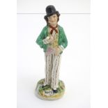 A Victorian Staffordshire pottery double-sided figure of a man standing on a circular,