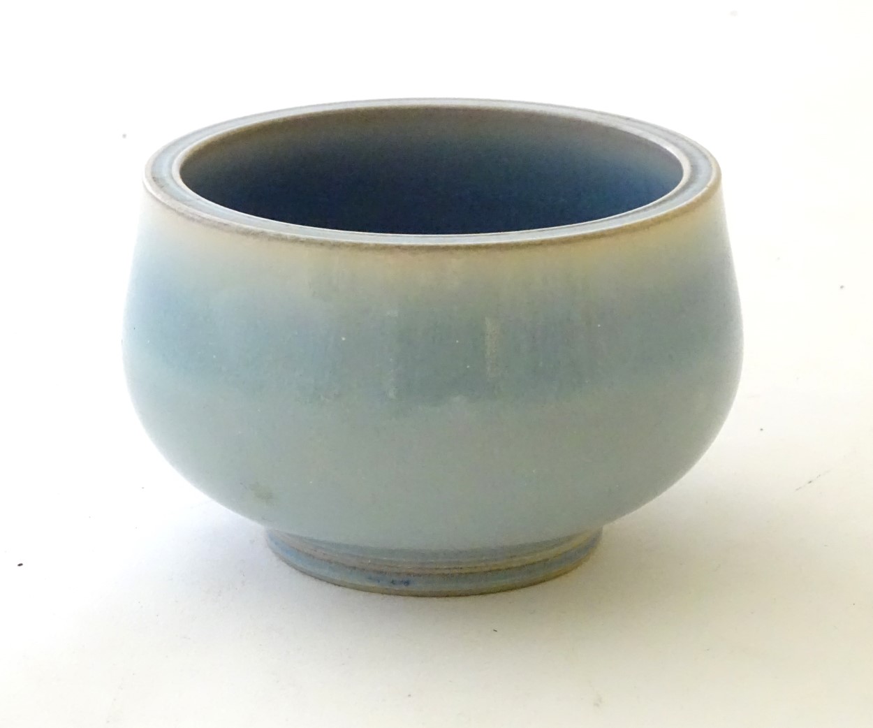 An unmarked high fired blue glazed bowl. Approx. 3" high. - Image 4 of 5