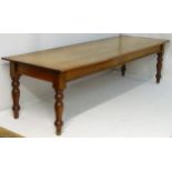 A late 19thC mahogany boardroom table / dining table standing on turned tapering legs.