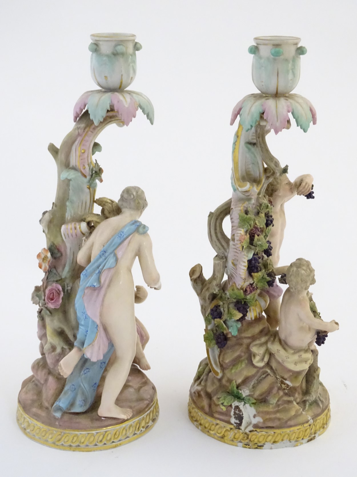 Two Meissen porcelain candlesticks, one depicting Bacchus and a child with vines and grapes, - Image 5 of 7