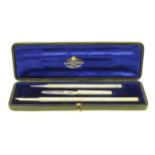 Sampson Mordan & Co : A cased 3 piece writing set comprising pencil, dip pen and paper knife/clip.