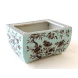 A Chinese turquoise oblong planter decorated with black cherry blossom and peonies,
