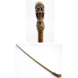 Folk-Art Walking Stick: A grotesque head walking cane,