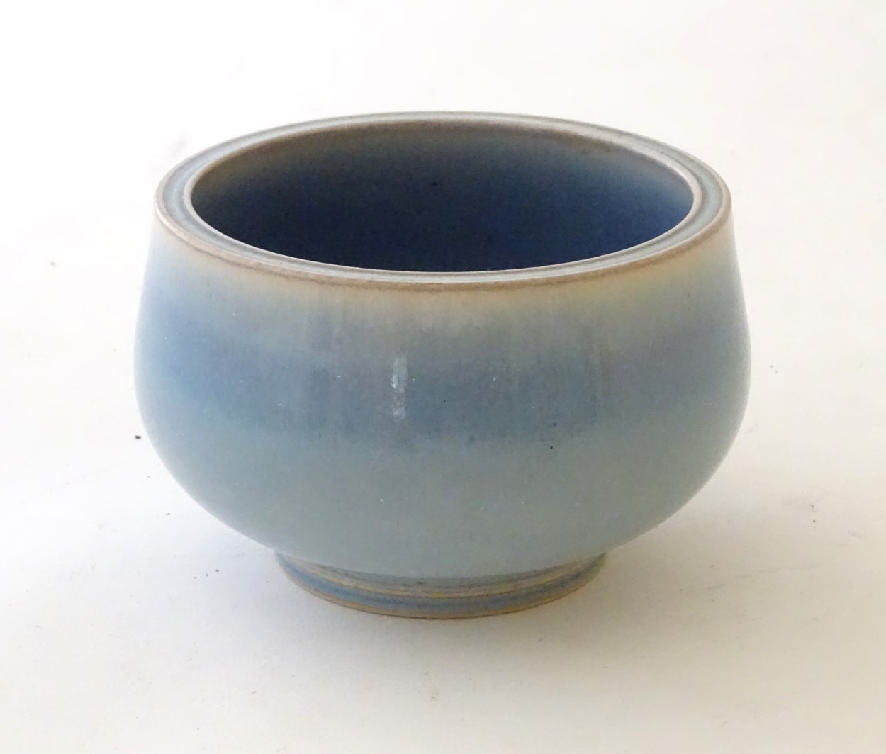 An unmarked high fired blue glazed bowl. Approx. 3" high.