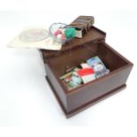 A small mahogany box containing sewing materials CONDITION: Please Note - we do not