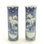 A pair of blue and white Japanese cylindrical vases with flared rims,