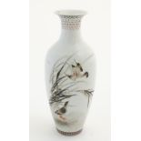 A small Oriental baluster vase, decorated with wader birds in reeds,