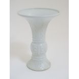 A Chinese white glazed Gu vase of archaic bronze design,