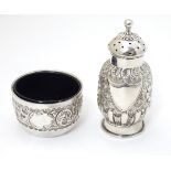 A Victorian silver embossed pepper pot hallmarked 1888 maker E S Barnsley & Co 3 1/2" high.